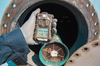 A Worker holding a measure device