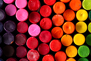 Box of crayons in a rainbow of colors background Box of crayons in a rainbow of colors background